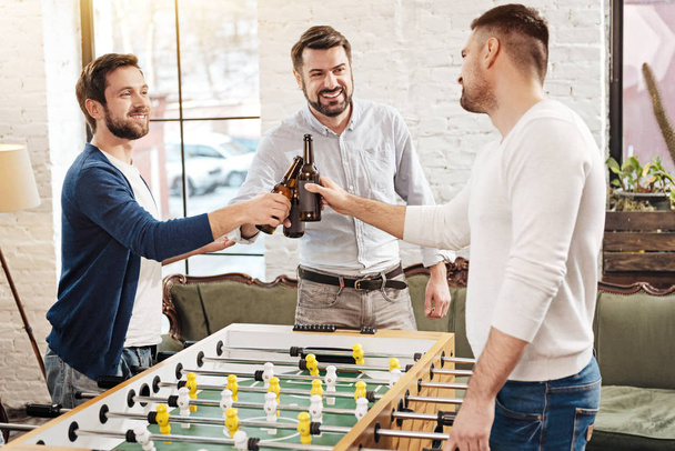 Positive male friends drinking beer - Фото, изображение