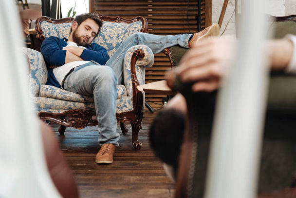 Handsome bearded man sleeping in the armchair - Фото, изображение