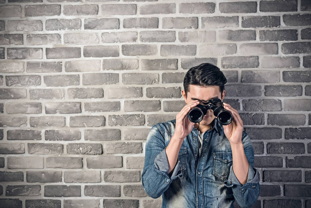 man hold a binoculars - Фото, изображение