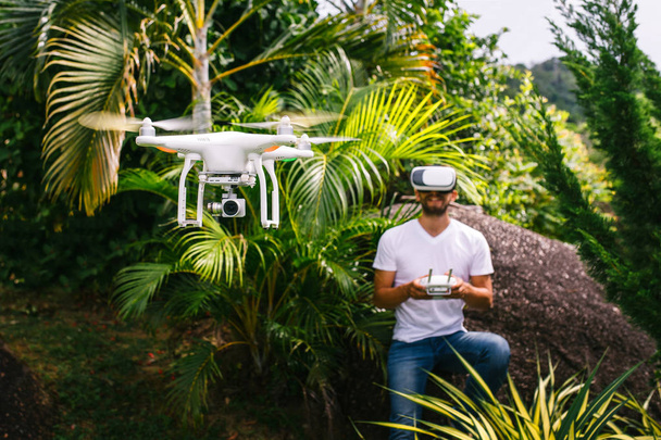 Man regelt een quadrocopter - Foto, afbeelding