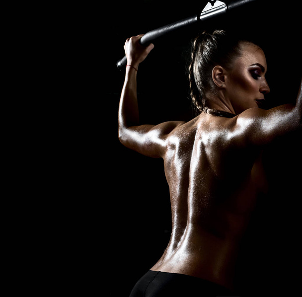 fitness woman execute exercise on black background - Photo, Image