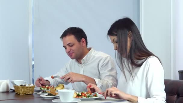 Young couple having really tasty lunch in a cafe - Footage, Video
