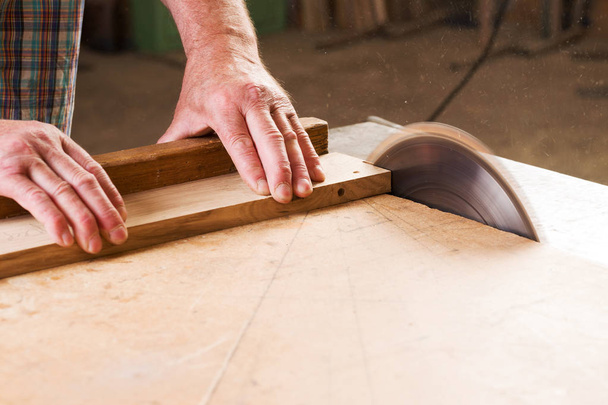 Carpenter tools on wooden table with sawdust. Circular Saw. - Fotó, kép