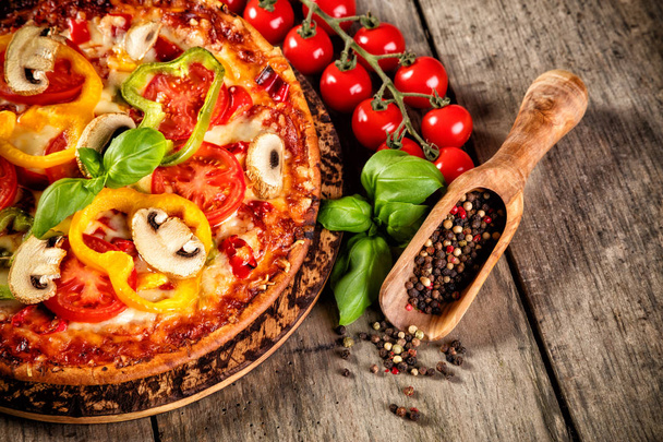 Pizza with ingredients served on wood - Фото, зображення