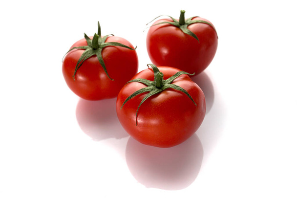 Three tomatoes on a white background - Zdjęcie, obraz