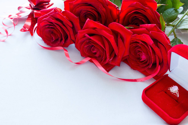 bouquet of red roses and wedding ring close-up with space for text - Photo, Image
