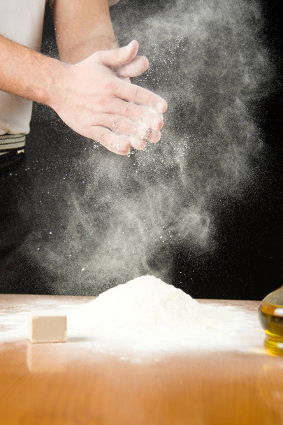 Man shaking of flour from hands - Photo, Image