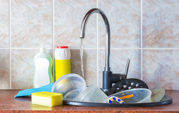 Dirty dishes in the sink. - 写真・画像