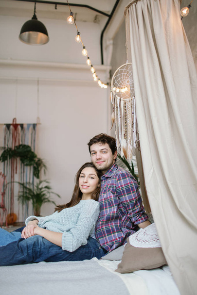 Young hipster couple having fun on handmade bed with dreamcatche - Fotografie, Obrázek