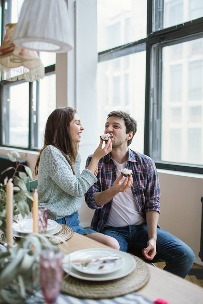 Young hipster couple feeding each other in rustic old loft - Foto, immagini