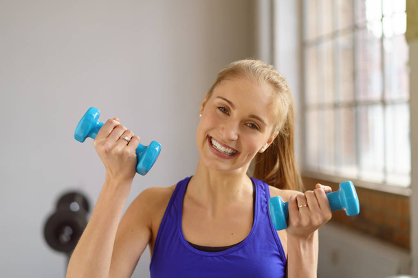 young girl working out with dumbbells - Photo, image