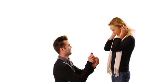 Young white man proposes to his girlfriend in front of white background - Foto, Bild