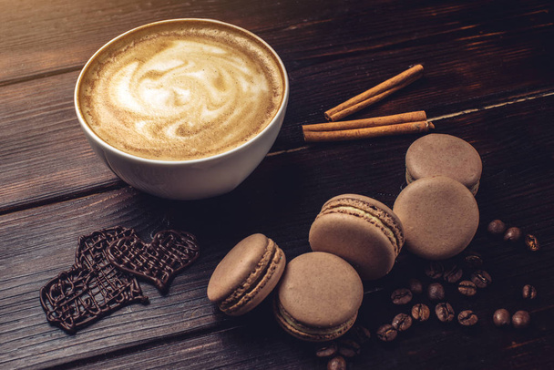 Coffee with macarons and chocolate in the shape of heart. - Photo, Image