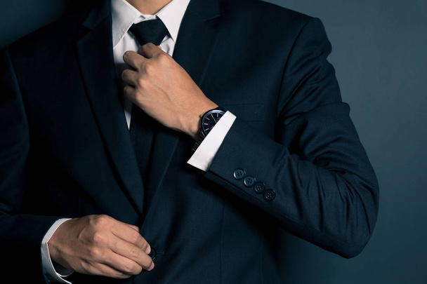 Businessman Adjusting His Necktie - Foto, Imagem