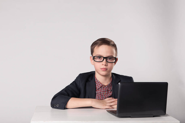 Young business boy working at the laptop - Fotó, kép