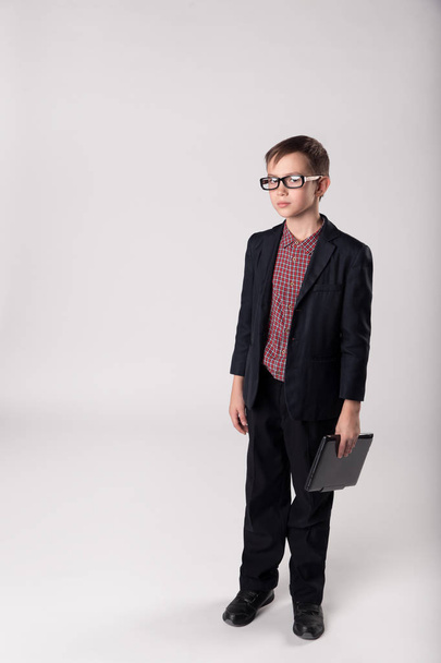 Serious business child boss with laptop - Φωτογραφία, εικόνα