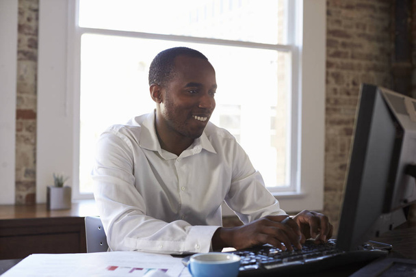 smiling Businessman Working On Computer   - Фото, изображение