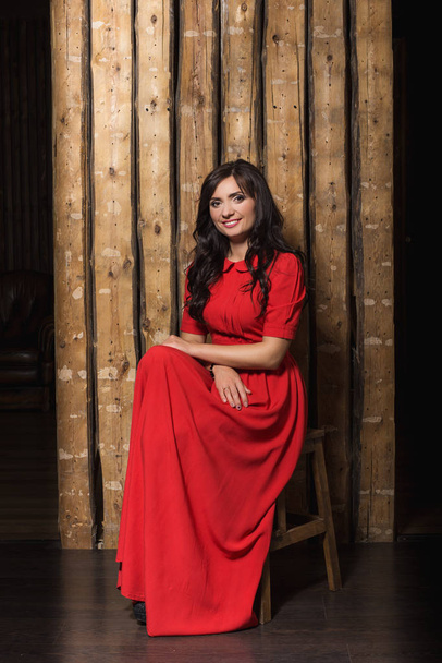 A beautiful woman in a red dress. Business woman.Fashion portrai - Zdjęcie, obraz