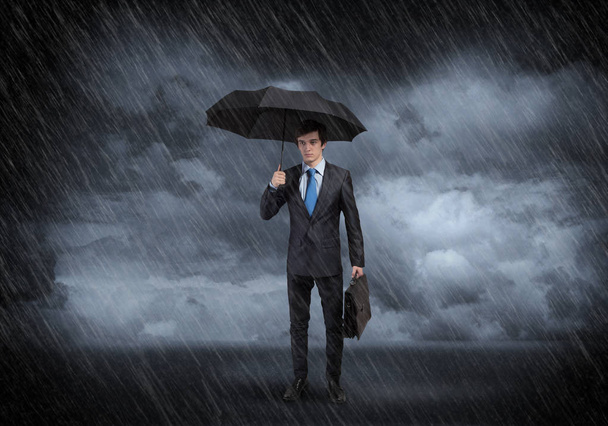 Young Businessman with umbrella - Fotó, kép