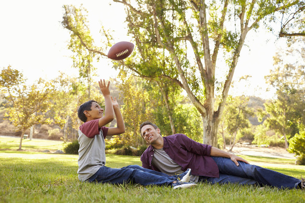 Father throwing football ball   - Foto, imagen