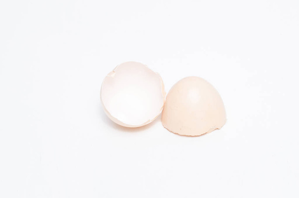Eggs chicken bird with egg yolk and shell on a gray background - Fotó, kép