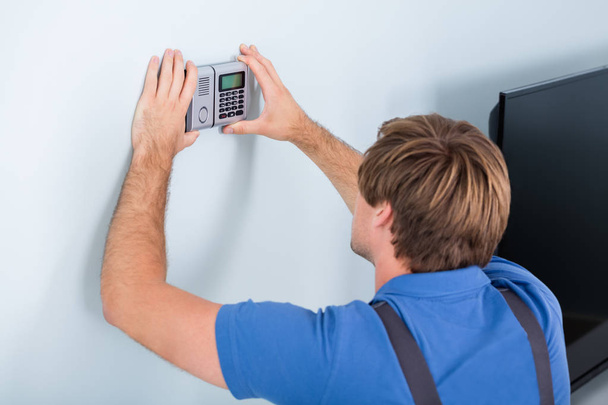 Repairman Installing Security System - Photo, Image
