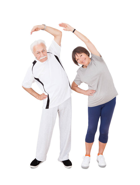 Active Senior Couple Doing Fitness. Isolated On White Background - Photo, Image