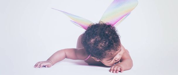 Pretty baby fairy wearing colorful wings letterbox - 写真・画像