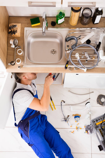 Male Plumber Repairing Sink - Фото, изображение
