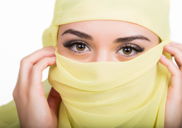 Asian girl with brown eyes posing in a yellow scarf, muslimah model in hijab isolated in white background - Foto, immagini