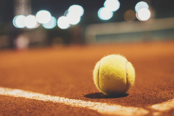 tennis ball on court at night - Foto, afbeelding