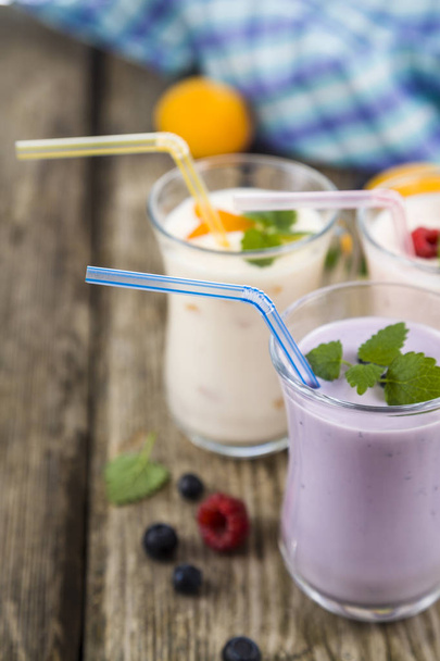 Smoothies or yogurt with fresh berries on a wooden table. - Photo, Image