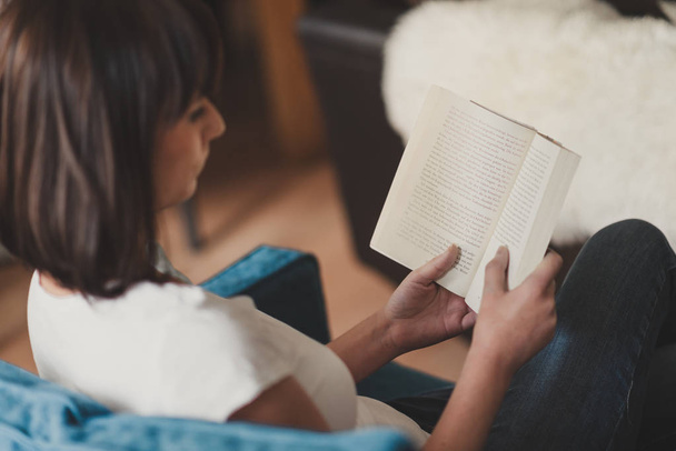 beautiful brunette woman reading a book - Photo, image