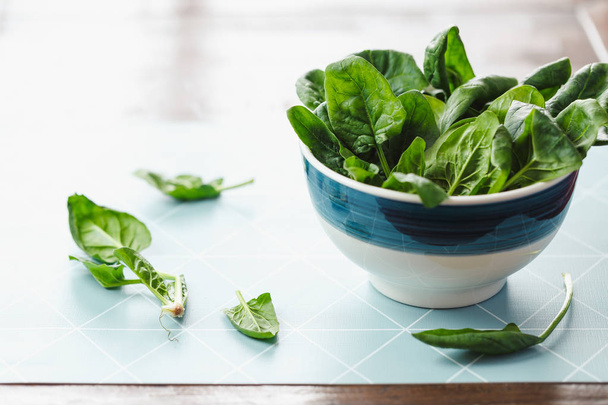 A bowl of fresh spinach leaves - Фото, изображение