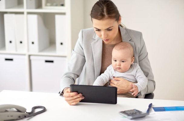 businesswoman with baby and tablet pc at office - Photo, Image