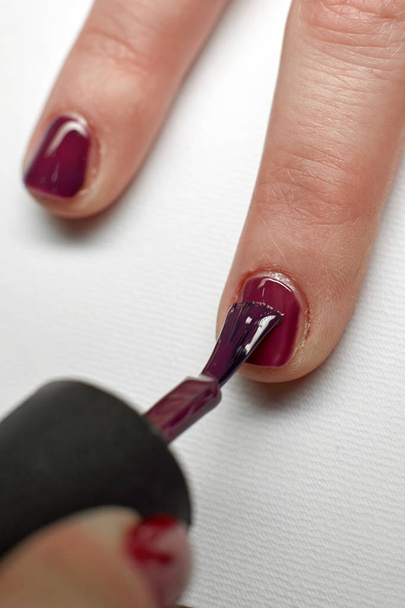 Manicure nail paint purple color. - Fotó, kép
