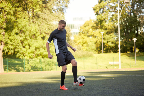 soccer player playing with ball on field - Fotó, kép