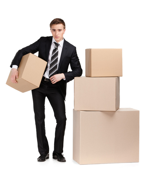 Manager stands near pile of boxes - Photo, Image
