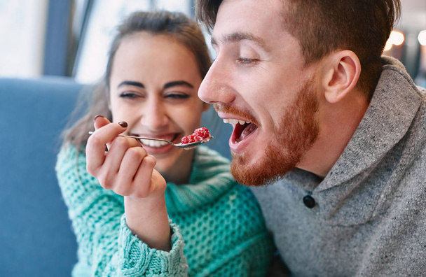 couple eating a dessert spoon in cafe on date - Φωτογραφία, εικόνα