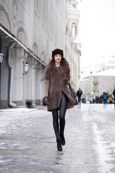 Young beautiful woman in stylish mink coat  - Фото, изображение