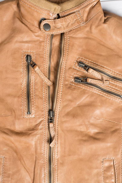 Light brown leather jacket. Beige color leather jacket on hanger. - Zdjęcie, obraz