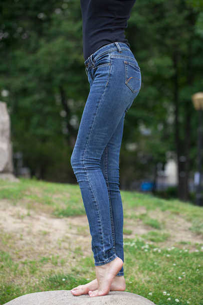 Back view of a long women legs posing with jeans - Foto, Bild