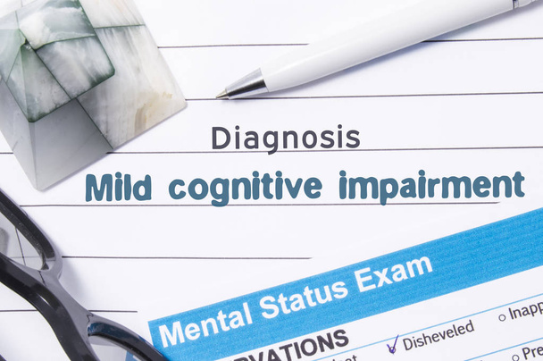 Psychiatric Diagnosis Mild Cognitive Impairment. Medical book or form with the name of diagnosis Mild Cognitive Impairment is on table of doctor surrounded by questionnaire to determine mental state - Photo, Image