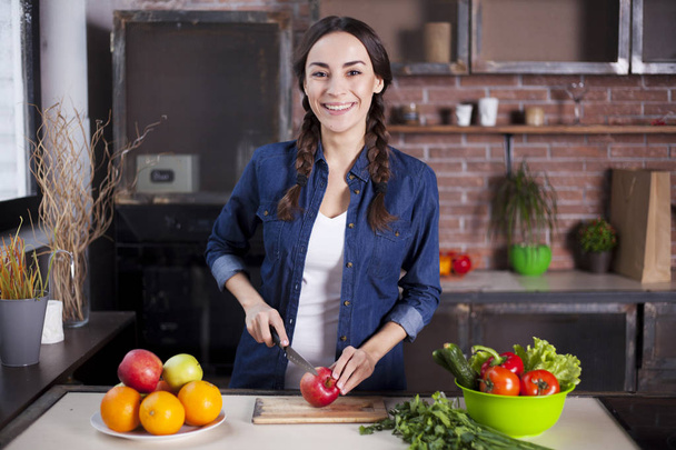 Young Woman Cooking in the kitchen at home. Healthy Food. Diet. Dieting Concept. Healthy Lifestyle. Cooking At Home. Prepare Food. Very Beautiful cheerful young brunette woman smiling. - Fotó, kép
