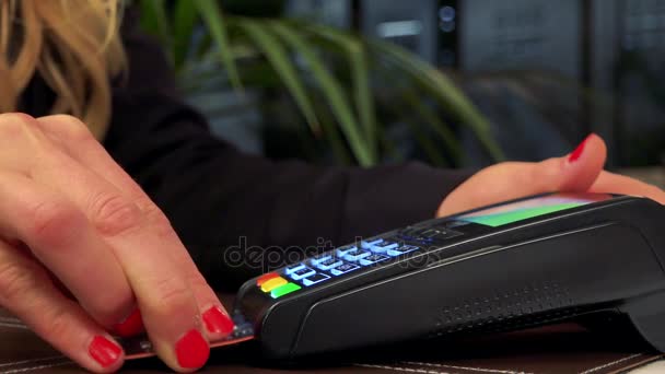 Μια γυναίκα εισάγει μια πιστωτική κάρτα σε ένα σαρωτή και τύπους για τον κωδικό πρόσβασης - κινηματογράφηση σε πρώτο πλάνο - Πλάνα, βίντεο