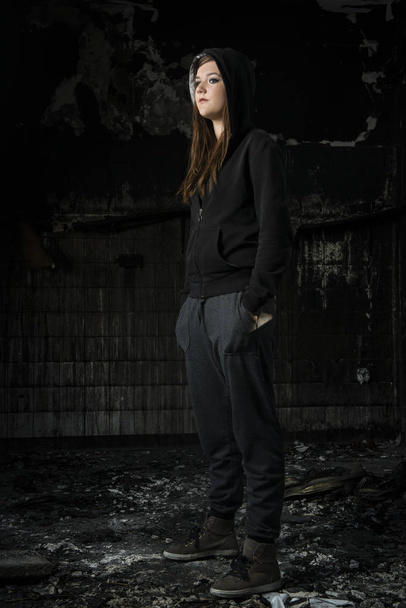 young woman in a burned house - Фото, зображення
