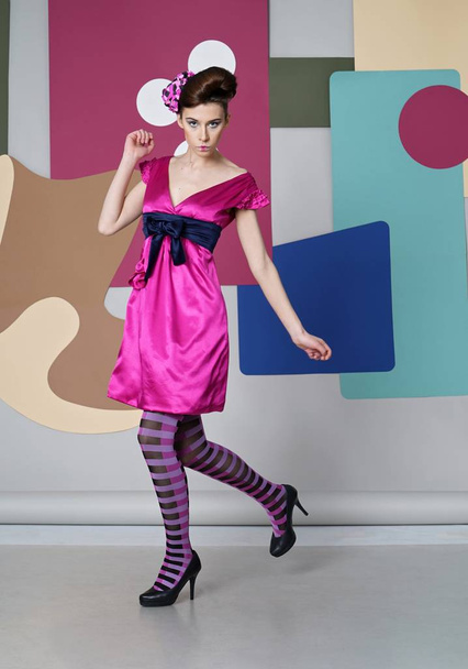 Pretty girl in eccentric dress dance on the color backdrop. Danish design. - Valokuva, kuva