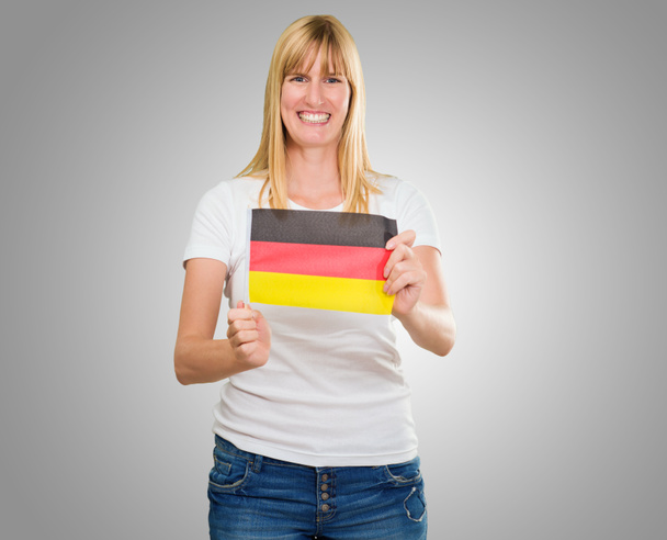 woman holding a german flag - Foto, afbeelding
