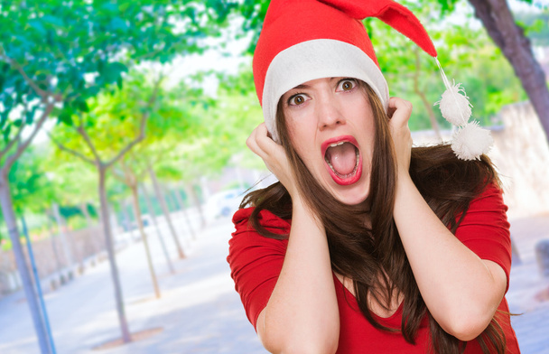 furious woman wearing a christmas hat - Photo, Image
