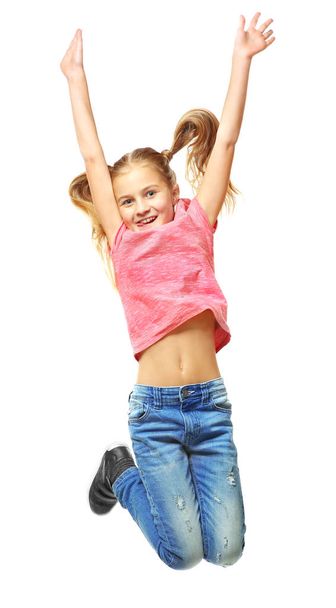 Emotional little girl jumping on white background - Фото, изображение